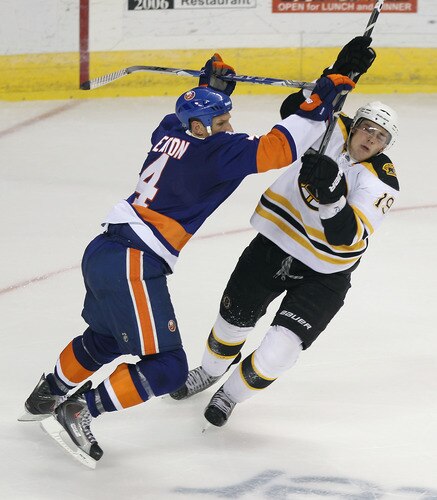 BRIDGEPORT, CT - OCTOBER 01: Mark Eaton #4 of the New York Islander hits Tyler Seguin #19 of the Boston Bruins at the Webster Bank Arena on October 1, 2011 in Bridgeport, Connecticut. The Bruins defeated the Islanders 3-2. <br /><br /><span class="help">(Photo by Bruce Bennett/Getty Images)</span>