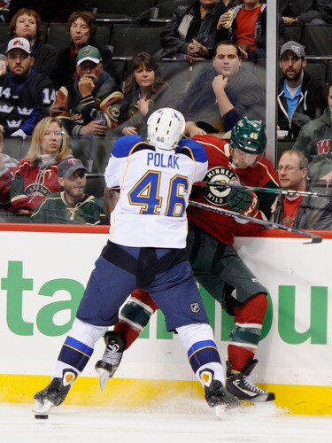 ST PAUL, MN - NOVEMBER 5: Roman Polak #46 of the St. Louis Blues checks Guillaume Latendresse #48 of the Minnesota Wild into the boards in the first period on November 5, 2011 at Xcel Energy Center in Minneapolis, Minnesota. <br /><br /><span class="help">(Photo by Hannah Foslien/Getty Images)</span>