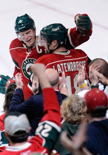 ST PAUL, MN - NOVEMBER 5: Mikko Koivu #9 of the Minnesota Wild congratulates Guillaume Latendresse #48 on scoring in the second period against the St. Louis Blues on November 5, 2011 at Xcel Energy Center in Minneapolis, Minnesota. The Wild defeated the Blues 2-1. <br /><br /><span class="help">(Photo by Hannah Foslien/Getty Images)</span>