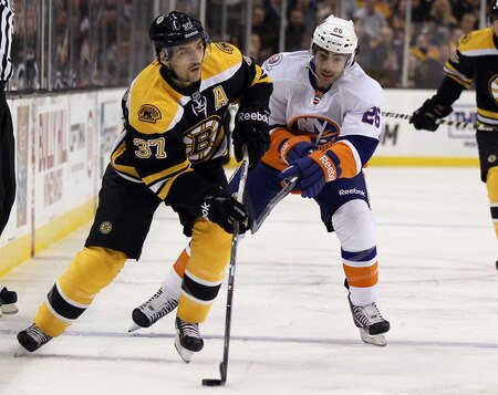 BOSTON, MA - NOVEMBER 07:  Patrice Bergeron #37 of the Boston Bruins heads for the net as Matt Moulson #26 of the New York Islanders defends on November 7, 2011 at TD Garden in Boston, Massachusetts.  <br /><br /><span class="help">(Photo by Elsa/Getty Images)</span>