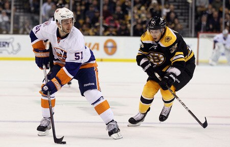 BOSTON, MA - NOVEMBER 07:  Frans Nielsen #51 of the New York Islanders looks to pass as Jordan Caron #38 of the Boston Bruins defends on November 7, 2011 at TD Garden in Boston, Massachusetts.  <br /><br /><span class="help">(Photo by Elsa/Getty Images)</span>