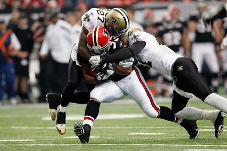 ATLANTA, GA - NOVEMBER 13:  Michael Turner #33 of the Atlanta Falcons is tackled by Malcolm Jenkins #27 of the New Orleans Saints and Roman Harper #41 at Georgia Dome on November 13, 2011 in Atlanta, Georgia.  <br /><br /><span class="help">(Photo by Kevin C. Cox/Getty Images)</span>