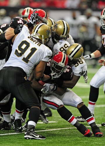 ATLANTA, GA - NOVEMBER 13: Jason Snelling #44 of the Atlanta Falcons is tackled by Will Smith #91 and Jo-Lonn Dunbar #56 of the New Orleans Saints at the Georgia Dome on November 13, 2011 in Atlanta, Georgia. <br /><br /><span class="help">(Photo by Scott Cunningham/Getty Images)</span>