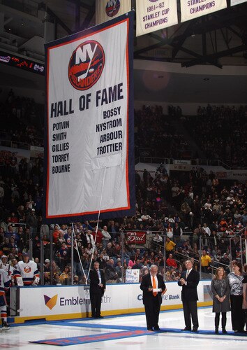 UNIONDALE, NY - NOVEMBER 19:  (L-R) Jiggs McDonald and Ed Westfall watch a banner raising in honor of Ed Westfall prior to the game between the New York Islanders and the Boston Bruins at the Nassau Veterans Memorial Coliseum on November 19, 2011 in Uniondale, New York.  <br /><br /><span class="help">(Photo by Bruce Bennett/Getty Images)</span>