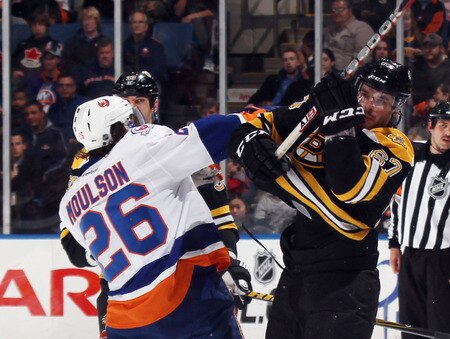 UNIONDALE, NY - NOVEMBER 19: Matt Moulson #26 of the New York Islanders hits Benoit Pouliot #67 of the Boston Bruins at the Nassau Veterans Memorial Coliseum on November 19, 2011 in Uniondale, New York.  <br /><br /><span class="help">(Photo by Bruce Bennett/Getty Images)</span>