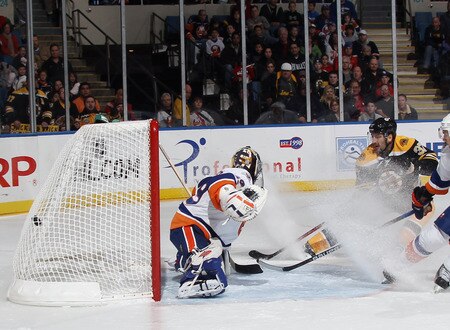 UNIONDALE, NY - NOVEMBER 19: Patrice Bergeron #37 of the Boston Bruins scores past Rick DiPietro #39 of the New York Islanders at 7:08 of the first period at the Nassau Veterans Memorial Coliseum on November 19, 2011 in Uniondale, New York.  <br /><br /><span class="help">(Photo by Bruce Bennett/Getty Images)</span>