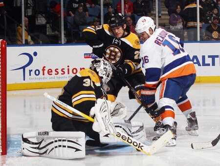 UNIONDALE, NY - NOVEMBER 19: Goaltender Tim Thomas #30 and defenseman Andrew Ference #21 of the Boston Bruins defend against Marty Reasoner #16 of the New York Islanders  at the Nassau Veterans Memorial Coliseum on November 19, 2011 in Uniondale, New York.  <br /><br /><span class="help">(Photo by Bruce Bennett/Getty Images)</span>