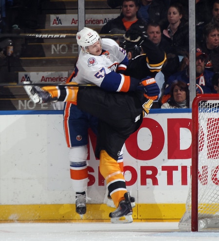 UNIONDALE, NY - NOVEMBER 19: Blake Comeau #57 of the New York Islanders hits Joe Corvo #14 of the Boston Bruins at the Nassau Veterans Memorial Coliseum on November 19, 2011 in Uniondale, New York. The Bruins defeated the Islanders 6-0. <br /><br /><span class="help">(Photo by Bruce Bennett/Getty Images)</span>