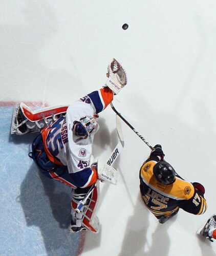 UNIONDALE, NY - NOVEMBER 19:  Playing in his first NHL game, Anders Nilsson #45 of the New York Islanders reaches for the puck as Milan Lucic #17 of the Boston Bruins  stands nearby at the Nassau Veterans Memorial Coliseum on November 19, 2011 in Uniondale, New York. The Bruins defeated the Islanders 6-0. <br /><br /><span class="help">(Photo by Bruce Bennett/Getty Images)</span>