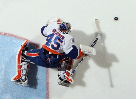 UNIONDALE, NY - NOVEMBER 19:  Playing in his first NHL game, Anders Nilsson #45 of the New York Islanders reaches for the puck against the Boston Bruins at the Nassau Veterans Memorial Coliseum on November 19, 2011 in Uniondale, New York. The Bruins defeated the Islanders 6-0.  <br /><br /><span class="help">(Photo by Bruce Bennett/Getty Images)</span>