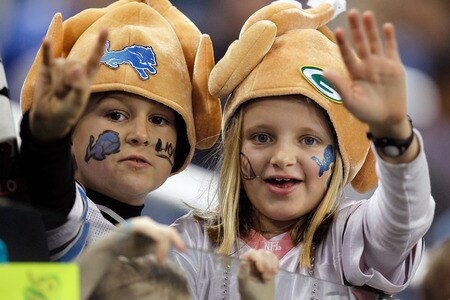 DETROIT, MI - NOVEMBER 24:  Two kids, a Detroit Lions fan and a Green Bay Packers fan, cheer on their teams before the Lions take on the Packers during the Thanksgiving Day game at Ford Field on November 24, 2011 in Detroit, Michigan.  <br /><br /><span class="help">(Photo by Gregory Shamus/Getty Images)</span>