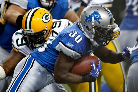 DETROIT, MI - NOVEMBER 24:  Running back Kevin Smith #30 of the Detroit Lions runs the ball as he is hit by Ryan Pickett #79 of the Green Bay Packers in the first quarter during the Thanksgiving Day game at Ford Field on November 24, 2011 in Detroit, Michigan.  <br /><br /><span class="help">(Photo by Gregory Shamus/Getty Images)</span>