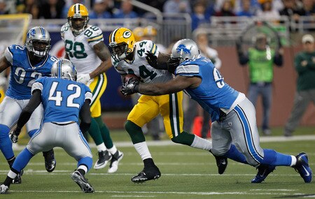 DETROIT, MI - NOVEMBER 24:  Running back James Starks #44 of the Green Bay Packers runs the ball as he is hit by Corey Williams #99 of the Detroit Lions in the first quarter during the Thanksgiving Day game at Ford Field on November 24, 2011 in Detroit, Michigan.  <br /><br /><span class="help">(Photo by Gregory Shamus/Getty Images)</span>