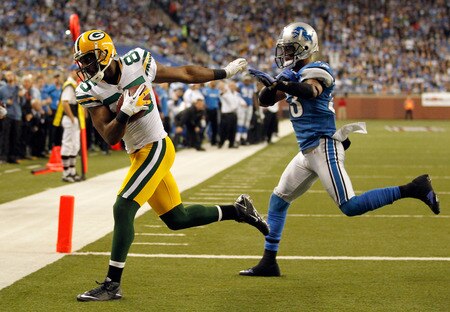 DETROIT, MI - NOVEMBER 24:  Wide receiver Greg Jennings #85 of the Green Bay Packers catches a three-yard touchdown pass against Brandon McDonald #33 of the Detroit Lions in the second quarter during the Thanksgiving Day game at Ford Field on November 24, 2011 in Detroit, Michigan.  <br /><br /><span class="help">(Photo by Gregory Shamus/Getty Images)</span>