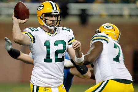 DETROIT, MI - NOVEMBER 24:  Quarterback Aaron Rodgers #12 of the Green Bay Packers looks to pass as defensive end Kyle Vanden Bosch #93 of the Detroit Lions rushes in during the first half of the Thanksgiving Day game at Ford Field on November 24, 2011 in Detroit, Michigan.  <br /><br /><span class="help">(Photo by Gregory Shamus/Getty Images)</span>