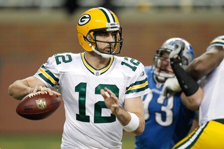 DETROIT, MI - NOVEMBER 24:  Quarterback Aaron Rodgers #12 of the Green Bay Packers looks to pass as defensive end Kyle Vanden Bosch #93 of the Detroit Lions rushes in during the first half of the Thanksgiving Day game at Ford Field on November 24, 2011 in Detroit, Michigan.  <br /><br /><span class="help">(Photo by Gregory Shamus/Getty Images)</span>