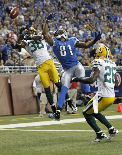 DETROIT, MI - NOVEMBER 24: Calvin Johnson #81 of the Detroit Lions battles for the ball with Tramon Williams #38 and Charlie Peprah #26 of the Green Bay Packers during the end of the second quarter at Ford Field on November 24, 2011 in Detroit, Michigan.  <br /><br /><span class="help">(Photo by Leon Halip/Getty Images)</span>