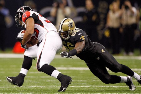 NEW ORLEANS, LA - DECEMBER 26:  Running back Michael Turner #33 of the Atlanta Falcons runs the ball against outside linebacker Jo-Lonn Dunbar #56 of the New Orleans Saints in the first half at the Mercedes-Benz Superdome on December 26, 2011 in New Orleans, Louisiana.  <br /><br /><span class="help">(Photo by Chris Graythen/Getty Images)</span>