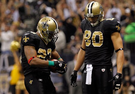 NEW ORLEANS, LA - DECEMBER 26:  Running back Pierre Thomas #23 of the New Orleans Saints reacts as he pulls out a bow and attaches it to the football after scoring on a four-yard touchdown run as he stands with tight end Jimmy Graham #80 against the Atlanta Falcons at the Mercedes-Benz Superdome on December 26, 2011 in New Orleans, Louisiana.  <br /><br /><span class="help">(Photo by Chris Graythen/Getty Images)</span>