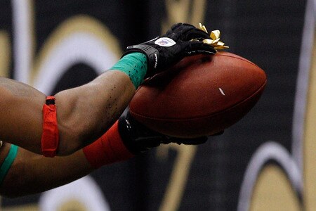 NEW ORLEANS, LA - DECEMBER 26:  Running back Pierre Thomas #23 of the New Orleans Saints heads towards the seats as he put a bow and attaches it to the football after scoring on a four-yard touchdown run against the Atlanta Falcons at the Mercedes-Benz Superdome on December 26, 2011 in New Orleans, Louisiana.  <br /><br /><span class="help">(Photo by Chris Graythen/Getty Images)</span>
