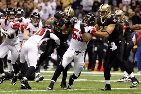 NEW ORLEANS, LA - DECEMBER 26:  Running back Pierre Thomas #23 of the New Orleans Saints runs the ball between defensive end Lawrence Sidbury #90 and outside linebacker Mike Peterson #53 of the Atlanta Falcons in the first half at the Mercedes-Benz Superdome on December 26, 2011 in New Orleans, Louisiana.  <br /><br /><span class="help">(Photo by Chris Graythen/Getty Images)</span>