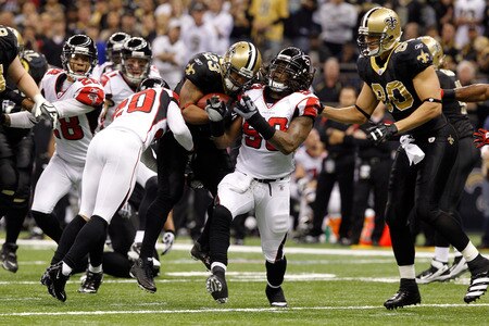 NEW ORLEANS, LA - DECEMBER 26:  Running back Pierre Thomas #23 of the New Orleans Saints runs the ball between cornerback Brent Grimes #20 and defensive end Lawrence Sidbury #90 of the Atlanta Falcons in the first half at the Mercedes-Benz Superdome on December 26, 2011 in New Orleans, Louisiana.  <br /><br /><span class="help">(Photo by Chris Graythen/Getty Images)</span>