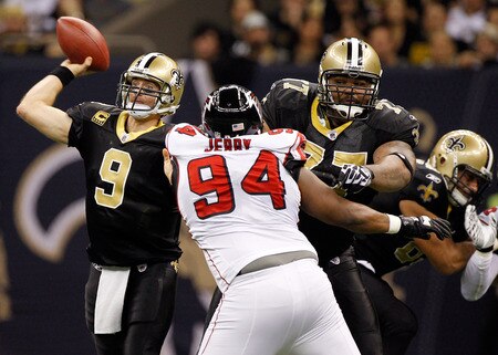 NEW ORLEANS, LA - DECEMBER 26:  Quarterback Drew Brees #9 of the New Orleans Saints passes the ball as he uses a block from offensive guard Carl Nicks #77 against defensive tackle Peria Jerry #94 of the Atlanta Falcons at the Mercedes-Benz Superdome on December 26, 2011 in New Orleans, Louisiana.  <br /><br /><span class="help">(Photo by Chris Graythen/Getty Images)</span>