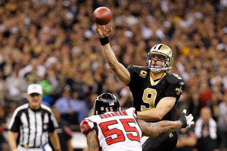 NEW ORLEANS, LA - DECEMBER 26:  Quarterback Drew Brees #9 of the New Orleans Saints throws the ball as defensive end John Abraham #55 of the Atlanta Falcons rushes in during the second quarter at the Mercedes-Benz Superdome on December 26, 2011 in New Orleans, Louisiana.  <br /><br /><span class="help">(Photo by Chris Graythen/Getty Images)</span>