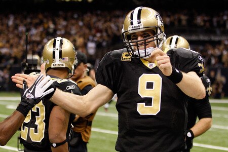 NEW ORLEANS, LA - DECEMBER 26:  (R) Quarterback Drew Brees #9 of the New Orleans Saints celebrates throwing a 24-yard third quarter touchdown pass against the Atlanta Falcons at the Mercedes-Benz Superdome on December 26, 2011 in New Orleans, Louisiana.  <br /><br /><span class="help">(Photo by Chris Graythen/Getty Images)</span>