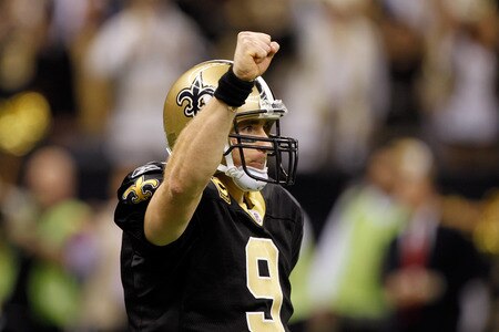 NEW ORLEANS, LA - DECEMBER 26:  Quarterback Drew Brees #9 of the New Orleans Saints reacts after throwing a nine-yard touchdown pass to running back Darren Sproles #43 and breaks the single-season passing record in the fourth quarter against the Atlanta Falcons at the Mercedes-Benz Superdome on December 26, 2011 in New Orleans, Louisiana.  <br /><br /><span class="help">(Photo by Chris Graythen/Getty Images)</span>