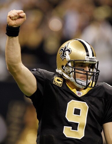 NEW ORLEANS, LA - DECEMBER 26:  Quarterback Drew Brees #9 of the New Orleans Saints reacts after throwing a nine-yard touchdown pass to running back Darren Sproles #43 and breaks the single-season passing record in the fourth quarter against the Atlanta Falcons at the Mercedes-Benz Superdome on December 26, 2011 in New Orleans, Louisiana.  <br /><br /><span class="help">(Photo by Chris Graythen/Getty Images)</span>