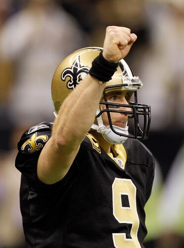 NEW ORLEANS, LA - DECEMBER 26:  Quarterback Drew Brees #9 of the New Orleans Saints reacts after throwing a nine-yard touchdown pass to running back Darren Sproles #43 and breaks the single-season passing record in the fourth quarter against the Atlanta Falcons at the Mercedes-Benz Superdome on December 26, 2011 in New Orleans, Louisiana.  <br /><br /><span class="help">(Photo by Chris Graythen/Getty Images)</span>