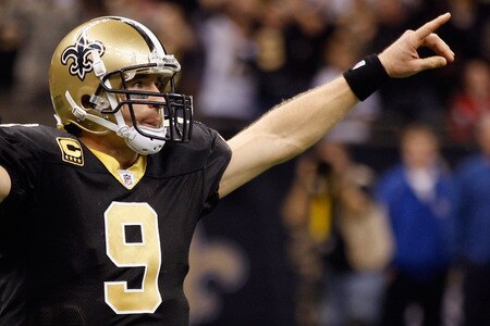 NEW ORLEANS, LA - DECEMBER 26:  Quarterback Drew Brees #9 of the New Orleans Saints celebrates after throwing a nine-yard touchdown pass to running back Darren Sproles #43 and breaks the single-season passing record in the fourth quarter against the Atlanta Falcons at the Mercedes-Benz Superdome on December 26, 2011 in New Orleans, Louisiana.  <br /><br /><span class="help">(Photo by Chris Graythen/Getty Images)</span>