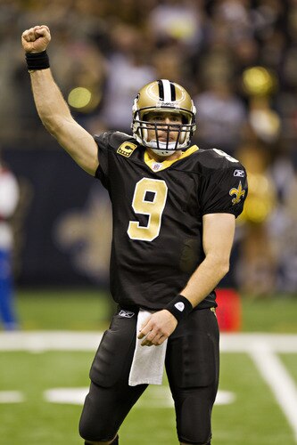 NEW ORLEANS, LA - DECEMBER 26:   Quarterback Drew Brees #9 of the New Orleans Saints celebrates after throwing a nine-yard touchdown pass to running back Darren Sproles #43 and broke the single-season passing record in the fourth quarter against the Atlanta Falcons at Mercedes-Benz Superdome on December 26, 2011 in New Orleans, Louisiana.  The Saints defeated the Falcons 45-16.  <br /><br /><span class="help">(Photo by Wesley Hitt/Getty Images)</span>