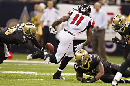 NEW ORLEANS, LA - DECEMBER 26:   Julio Jones #11 of the Atlanta Falcons fumbles the ball after catching a pass against the New Orleans Saints at Mercedes-Benz Superdome on December 26, 2011 in New Orleans, Louisiana.  The Saints defeated the Falcons 45-16.  <br /><br /><span class="help">(Photo by Wesley Hitt/Getty Images)</span>