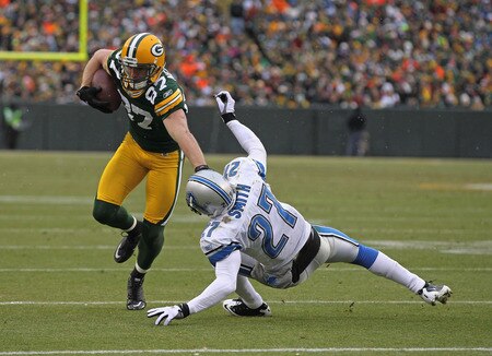 GREEN BAY, WI - JANUARY 01: Jordy Nelson #87 of the Green Bay Packers stiff-arms Alphonso Smith #27 of the Detroit Lions on his way to scoring a touchdown at Lambeau Field on January 1, 2012 in Green Bay, Wisconsin. <br /><br /><span class="help">(Photo by Jonathan Daniel/Getty Images)</span>