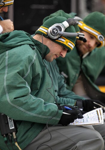 GREEN BAY, WI - JANUARY 01: Aaron Rodgers #12 of the Green Bay Packers, who did not dress for a game against the Detroit Lions, looks at formation photos on the bench at Lambeau Field on January 1, 2012 in Green Bay, Wisconsin. <br /><br /><span class="help">(Photo by Jonathan Daniel/Getty Images)</span>