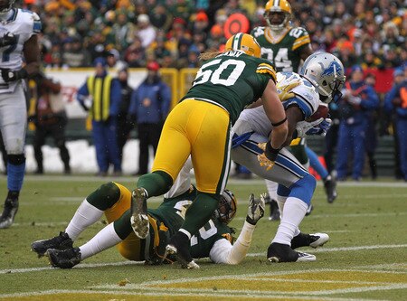 GREEN BAY, WI - JANUARY 01: Calvin Johnson #81 of the Detroit Lions catches a touchdown pass against Morgan Burnett #42 and A.J. Hawk #50 of the Green Bay Packers at Lambeau Field on January 1, 2012 in Green Bay, Wisconsin.  <br /><br /><span class="help">(Photo by Jonathan Daniel/Getty Images)</span>