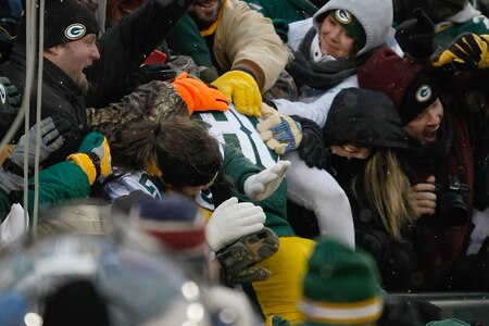 GREEN BAY, WI - JANUARY 1: Jermichael Finley #88 of the Green Bay Packers is swarmed by fans after scoring a touchdown during the game against the Detroit Lions at Lambeau Field on January 1, 2012 in Green Bay, Wisconsin. The Packers defeated the Lions 45-41. <br /><br /><span class="help">(Photo by Scott Boehm/Getty Images)</span>