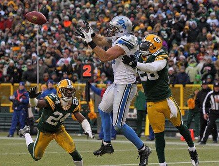 GREEN BAY, WI - JANUARY 01:  Tony Scheffler #85 of the Detroit Lions catches a touchdown pass between Jarrett Bush #24 and Charlie Peprah #26 of the Green Bay Packers at Lambeau Field on January 1, 2012 in Green Bay, Wisconsin. The Packers defeated the Lions 45-41.  <br /><br /><span class="help">(Photo by Jonathan Daniel/Getty Images)</span>