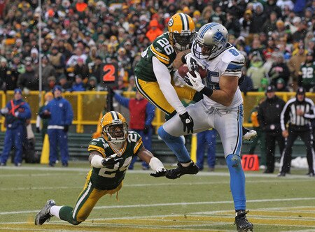 GREEN BAY, WI - JANUARY 01:  Tony Scheffler #85 of the Detroit Lions catches a touchdown pass between Jarrett Bush #24 and Charlie Peprah #26 of the Green Bay Packers at Lambeau Field on January 1, 2012 in Green Bay, Wisconsin. The Packers defeated the Lions 45-41.  <br /><br /><span class="help">(Photo by Jonathan Daniel/Getty Images)</span>