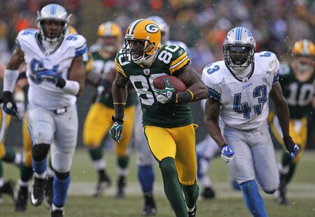GREEN BAY, WI - JANUARY 01:  Donald Driver #80 of the Green Bay Packers breaks away from Chris Harris #43 and Lawrence Jackson #94 of the Detroit Lions to score a touchdown at Lambeau Field on January 1, 2012 in Green Bay, Wisconsin. The Packers defeated the Lions 45-41.  <br /><br /><span class="help">(Photo by Jonathan Daniel/Getty Images)</span>