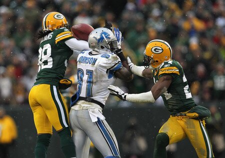 GREEN BAY, WI - JANUARY 01: Tramon Williams #38 of the Green Bay Packers breaks up a pass intended for Clavin Johnson #81 of the Detroit Lions as Jarrett Bush #24 also defends at Lambeau Field on January 1, 2012 in Green Bay, Wisconsin. The Packers defeated the Lions 45-41. <br /><br /><span class="help">(Photo by Jonathan Daniel/Getty Images)</span>