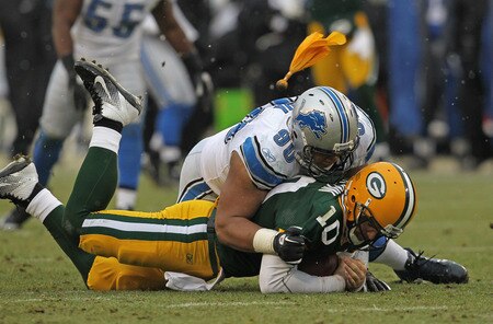 GREEN BAY, WI - JANUARY 01: A penalty flag flies over the head of Ndamukong Suh #90 of the Detroit Lions as he sacks Matt Flynn #10 of the Green Bay Packers at Lambeau Field on January 1, 2012 in Green Bay, Wisconsin. The Packers defeated the Lions 45-41.  <br /><br /><span class="help">(Photo by Jonathan Daniel/Getty Images)</span>