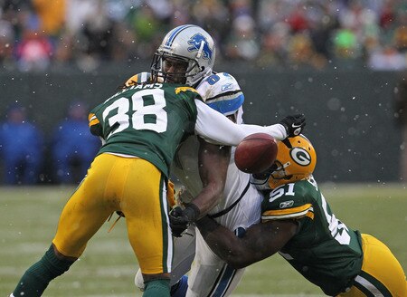 GREEN BAY, WI - JANUARY 01:  Brandon Pettigrew #87 of the Detroit Lions drops the ball as he is hit by Tramon Williams #38 and D.J. Smith #51 of the Green Bay Packers at Lambeau Field on January 1, 2012 in Green Bay, Wisconsin. The Packers defeated the Lions 45-41.  <br /><br /><span class="help">(Photo by Jonathan Daniel/Getty Images)</span>