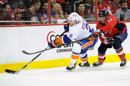 WASHINGTON, DC - JANUARY 17:  Mark Streit #2 of the New York Islanders battles for the puck against Jay Beagle #83 of the Washington Capitals at the Verizon Center on January 17, 2012 in Washington, DC.  <br /><br /><span class="help">(Photo by Greg Fiume/Getty Images)</span>
