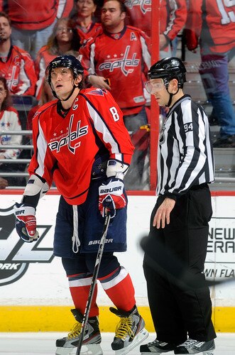 WASHINGTON, DC - JANUARY 17:  Alex Ovechkin #8 of the Washington Capitals is led to the penalty box by linesman Bryan Pancich after a cross-checking penalty against the New York Islanders at the Verizon Center on January 17, 2012 in Washington, DC.  <br /><br /><span class="help">(Photo by Greg Fiume/Getty Images)</span>