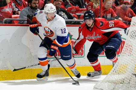 WASHINGTON, DC - JANUARY 17:  Josh Bailey #12 of the New York Islanders brings the puck around the net against Marcus Johansson #90 the Washington Capitals at the Verizon Center on January 17, 2012 in Washington, DC.  <br /><br /><span class="help">(Photo by Greg Fiume/Getty Images)</span>
