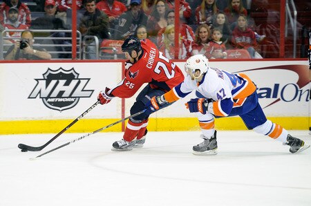 WASHINGTON, DC - JANUARY 17:  Jason Chimera #25 of the Washington Capitals handles the puck against Andrew MacDonald #47 of the New York Islanders at the Verizon Center on January 17, 2012 in Washington, DC.  The Islanders won the game 3-0.  <br /><br /><span class="help">(Photo by Greg Fiume/Getty Images)</span>