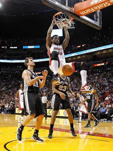 MIAMI, FL - JANUARY 17:  Udonis Haslem #40 of the Miami Heat dunks over Tiago Splitter #22 of the San Antonio Spurs during a game  at American Airlines Arena on January 17, 2012 in Miami, Florida. <br /><br /><span class="help">(Photo by Mike Ehrmann/Getty Images)</span>